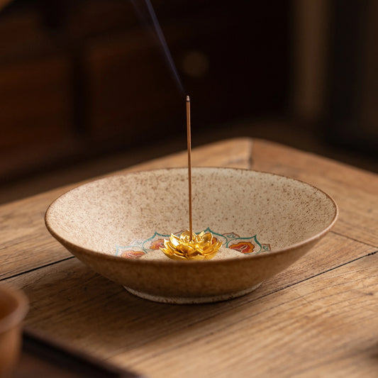 Zen style pottery incense burner emitting smoke, beige textured ceramic tray for yoga studio or home altar