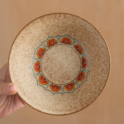 Top view of handheld coarse pottery incense plate featuring hand-painted Dunhuang floral patterns and earth tones.