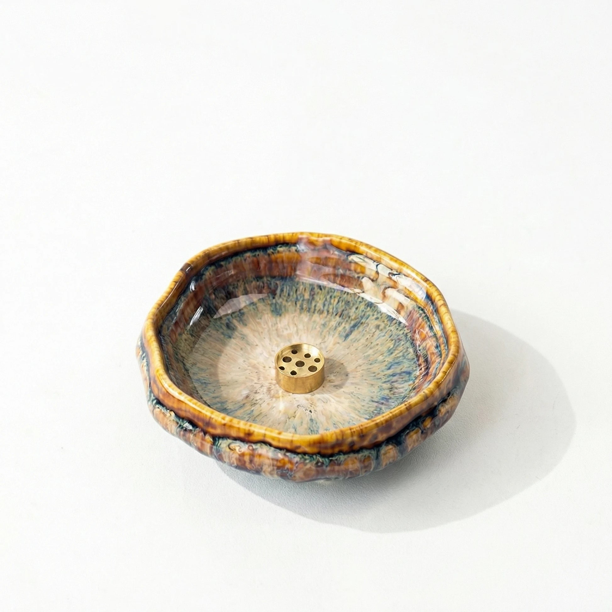 Close-up of a kiln-transmuted glaze incense bowl with intricate ice-crack patterns and a 9-hole brass incense stick holder