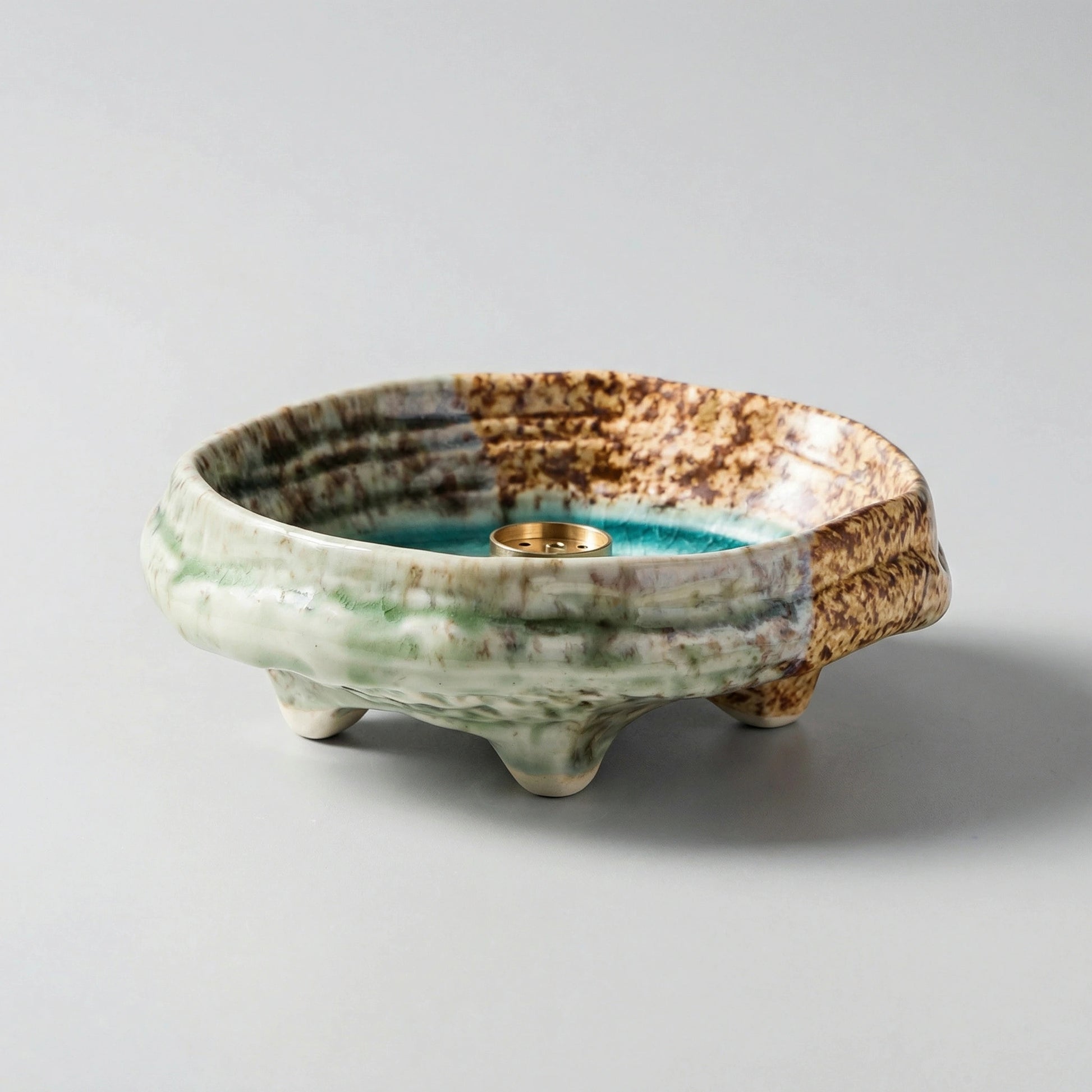 Detailed view of the emerald green ice-crackle texture on a handcrafted zen ceramic incense burner
