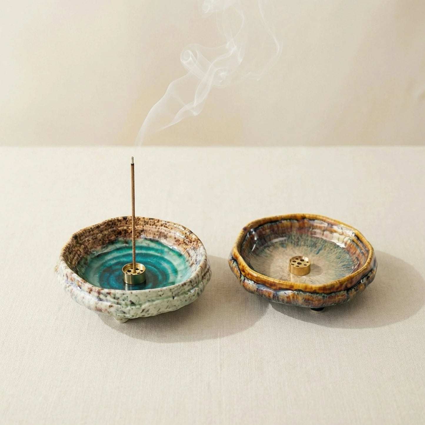 Artisan kiln-fired ceramic incense burners on a wooden table, showcasing unique transmutation glaze patterns.