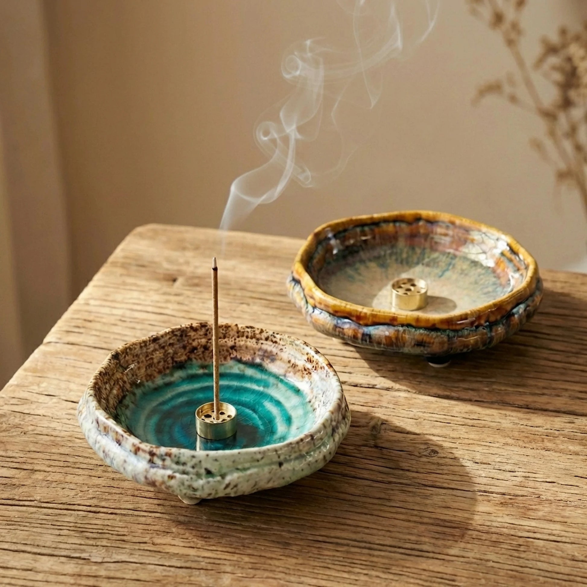 Artisan kiln-fired ceramic incense burners on a wooden table, showcasing unique transmutation glaze patterns.