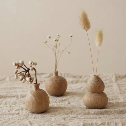 Set of three different shaped mini white oak vases: round, slim, and gourd styles with dried botanicals.