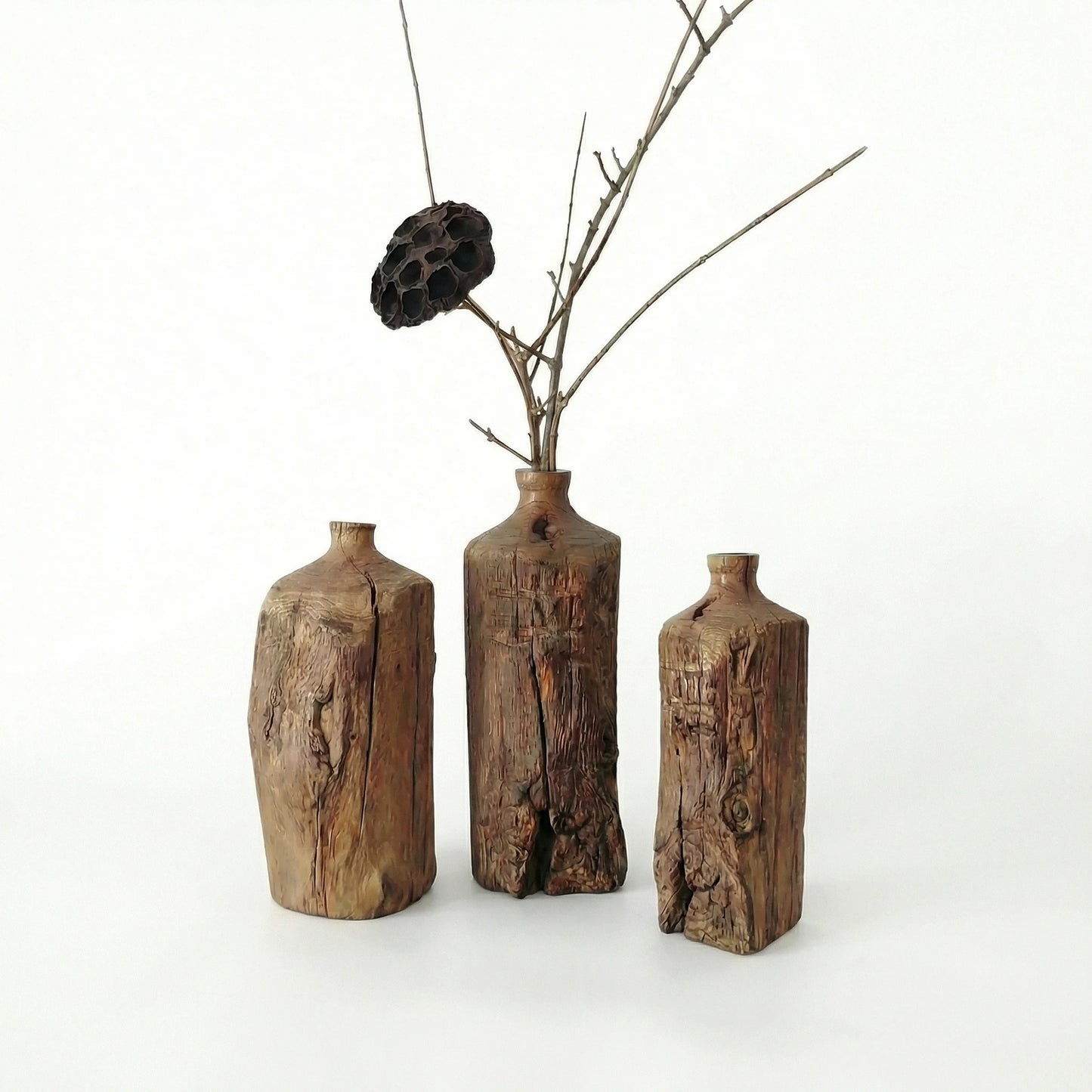 Trio of Wabi-sabi style reclaimed wood vases with dried lotus pod, rustic farmhouse table decor