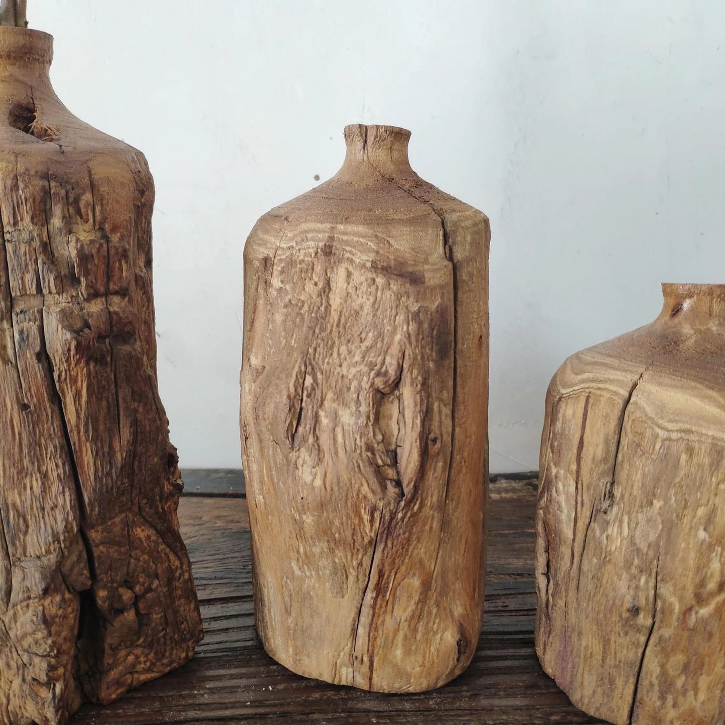 Close-up of natural wood grain and rustic cracks on a handmade Wabi-sabi wooden vase