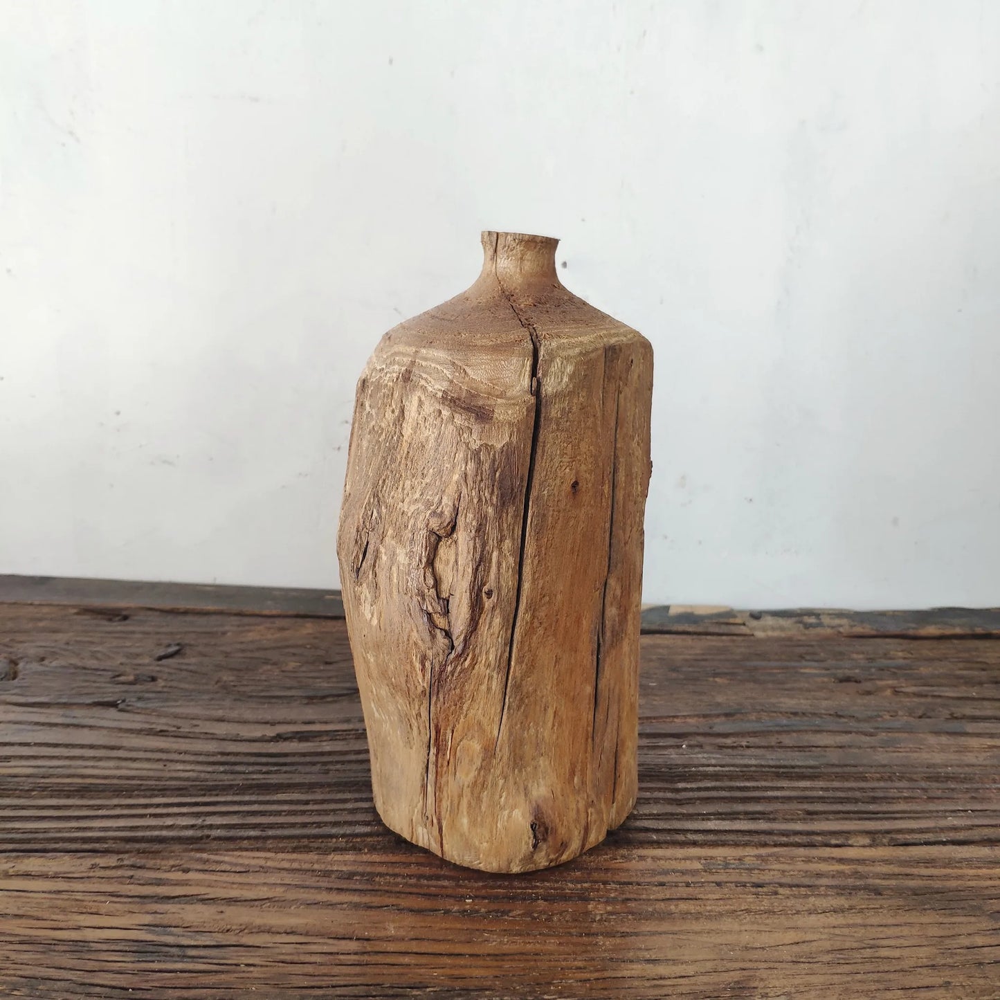 Tall cylindrical reclaimed wood vase with natural split, rustic minimalist shelf centerpiece.