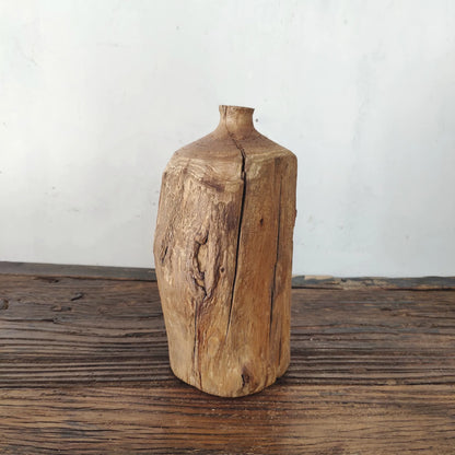 Tall cylindrical reclaimed wood vase with natural split, rustic minimalist shelf centerpiece.
