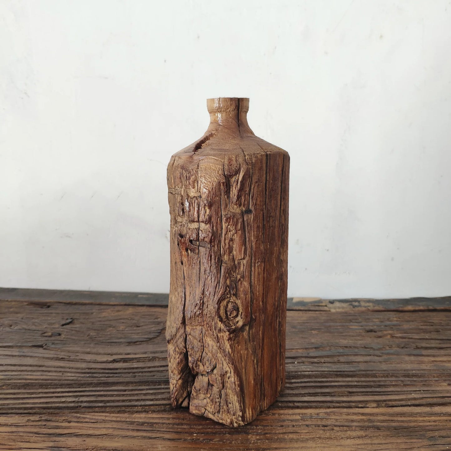 Weathered dark wood tall vase with deep vertical grain, rustic wabi-sabi accent piece