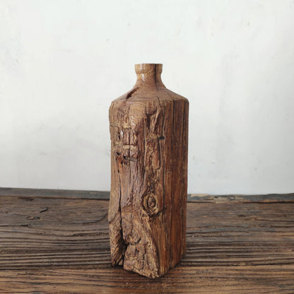 Weathered dark wood tall vase with deep vertical grain, rustic wabi-sabi accent piece
